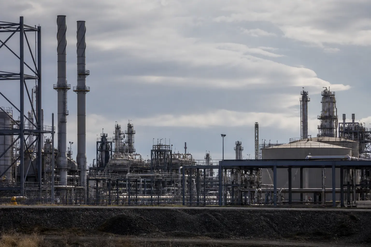 An onshore energy industrial estate under a pale sky
